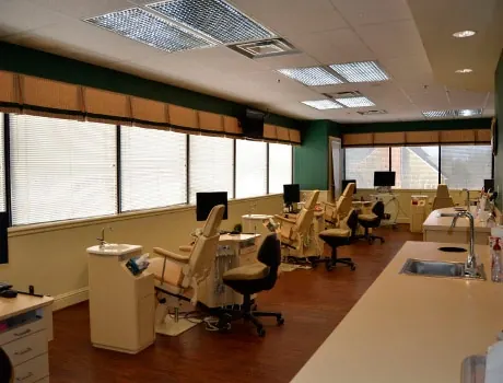 The open treatment bay at the Towson office, with orthodontic chairs along the windows.