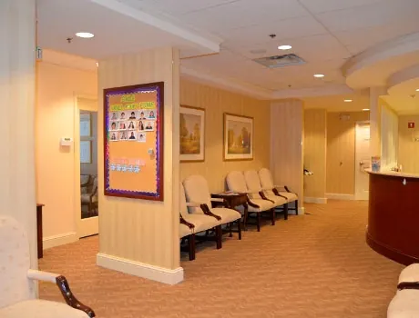 The waiting area at the Towson office, with a board of patient photographs on the pillar.